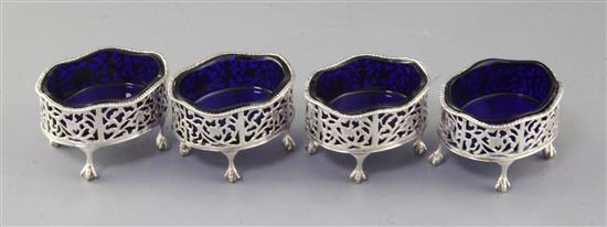 A set of four George III pierced silver oval salts with blue glass liners, by Andrew Fogelberg, 82mm.